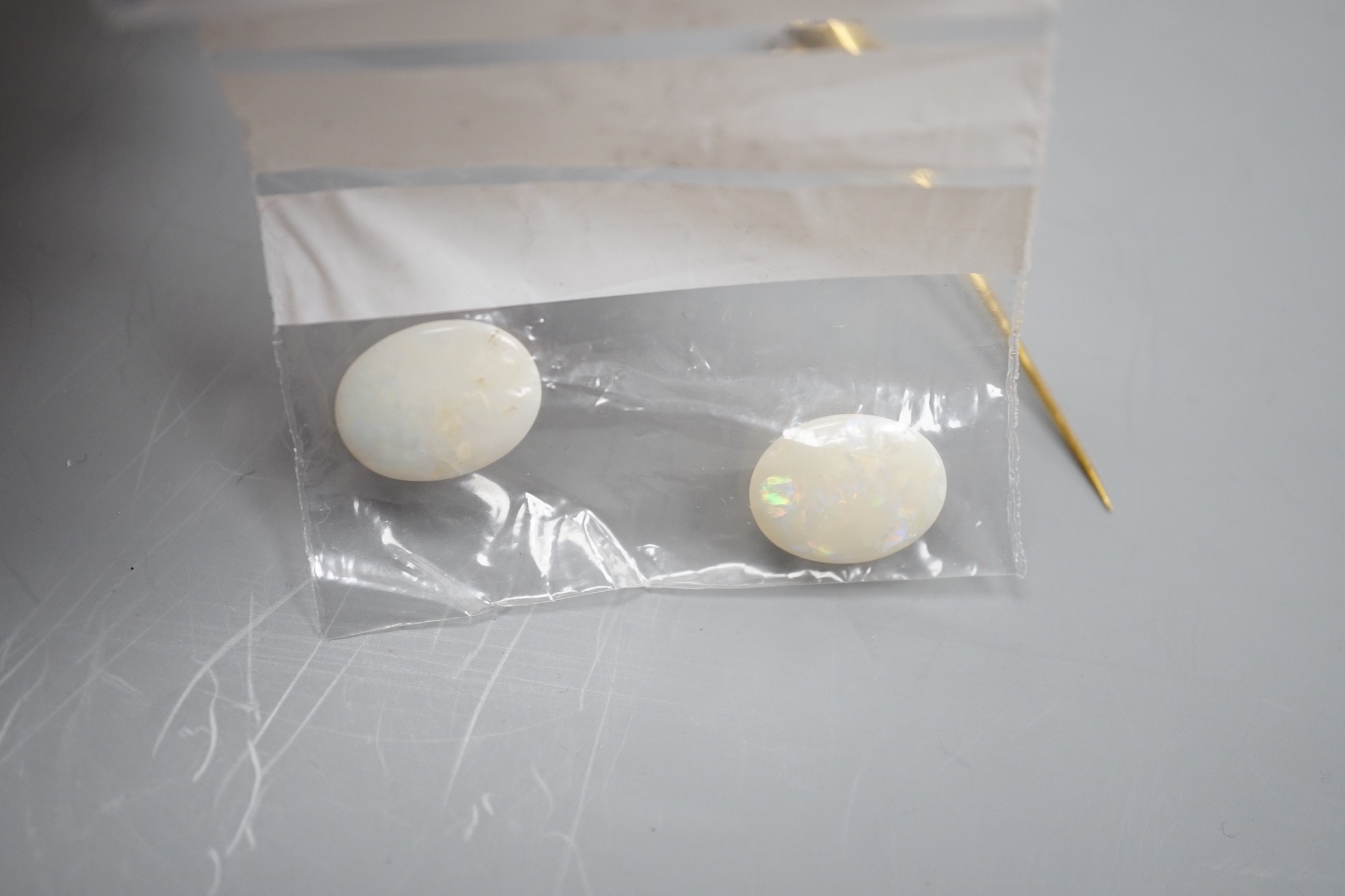 Two unmounted oval white opals, approx. 16mm and a yellow metal, cultured pearl and gem set stick pin.